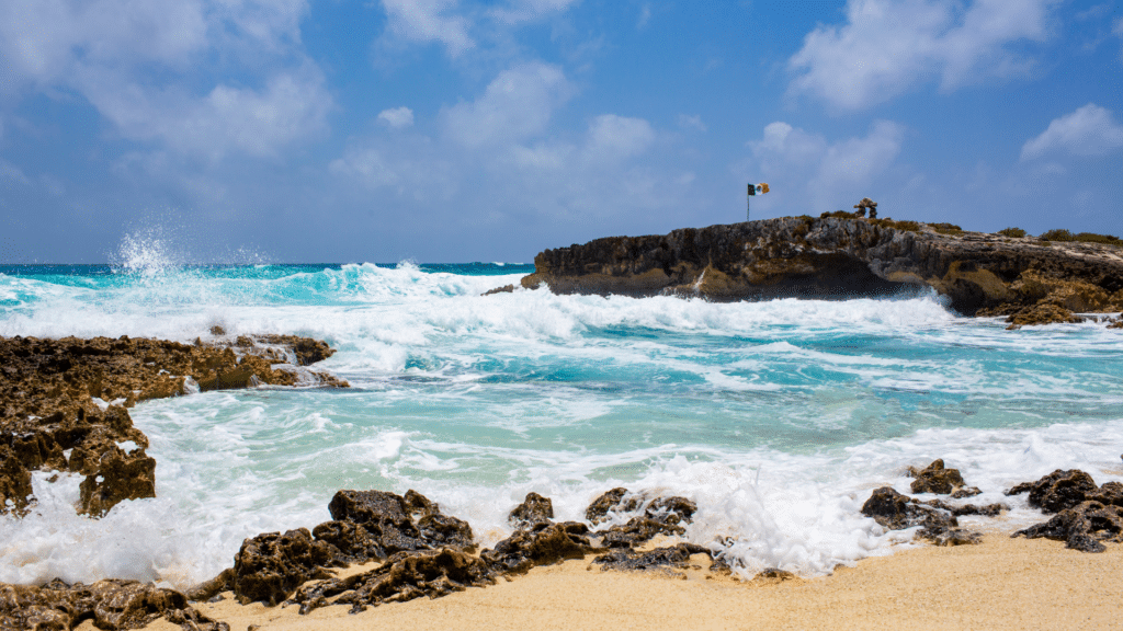 Turquoise Caribbean waves breaking along a rocky Mexico coast